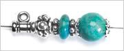 turquoise round beads, silver-plated bead caps, sterling silver beaded rondelles and a magnesite rondelle on beading wire